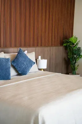 a bedroom with a large bed with blue pillows at San Blas Loft in Playa San Blas