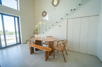 a dining room with a wooden table and chairs at San Blas Loft in Playa San Blas