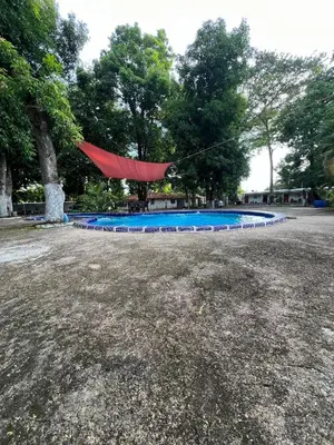 a red tarp is hanging over a swimming pool at Sunzal Tropical 9 in Tamanique