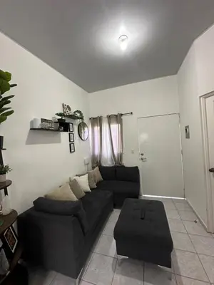 a living room with a black couch and a table at Villa panamericana san miguel in San Miguel
