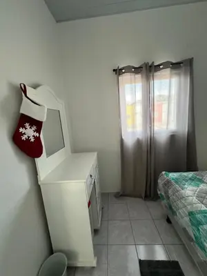 a room with a dresser with a mirror and a bed at Villa panamericana san miguel in San Miguel