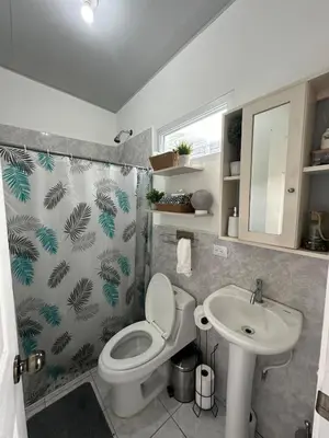 a bathroom with a toilet and a sink at Villa panamericana san miguel in San Miguel
