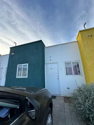 a car parked in front of a white and green building at Villa panamericana san miguel in San Miguel