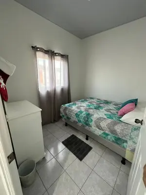 a small bedroom with a bed and a window at Villa panamericana san miguel in San Miguel