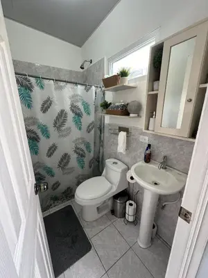 a bathroom with a toilet and a sink at Villa panamericana san miguel in San Miguel