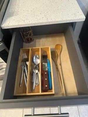 a drawer with utensils in a box under a counter at Villa panamericana san miguel in San Miguel