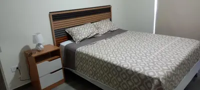 a bedroom with a bed and a nightstand with a bed sidx sidx sidx sidx at Apto 52 Lomas in Antiguo Cuscatlán