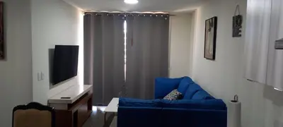 a living room with a blue couch and a television at Apto 52 Lomas in Antiguo Cuscatlán