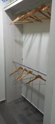 a shelf in a white wall with wooden sticks on it at Apto 52 Lomas in Antiguo Cuscatlán