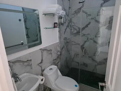 a bathroom with a toilet and a sink and a shower at Casa Nueva San Miguel in San Miguel