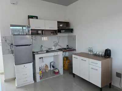 a small kitchen with white cabinets and a counter at Casa Nueva San Miguel in San Miguel