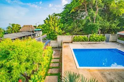 an image of a swimming pool in a garden at Casa Las Flores in El Cuco