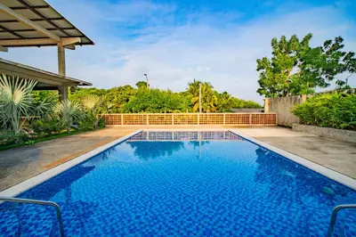 a swimming pool in the backyard of a house at Casa Las Flores in El Cuco