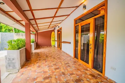 an internal walkway of a house with glass doors at Casa Las Flores in El Cuco