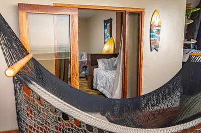 a hammock in a room with a bedroom at AST Surf Hotel in La Libertad