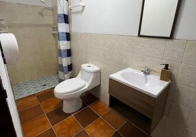 a bathroom with a toilet and a sink at Quinta Hojas de Mar - Frente al Mar en Playa Las Hojas in El Rosario