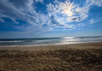 a beach with a cloudy sky and the ocean at Quinta Hojas de Mar - Frente al Mar en Playa Las Hojas in El Rosario