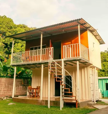 a house with a staircase leading up to it at Hotel Castillo Blanco in El Zonte