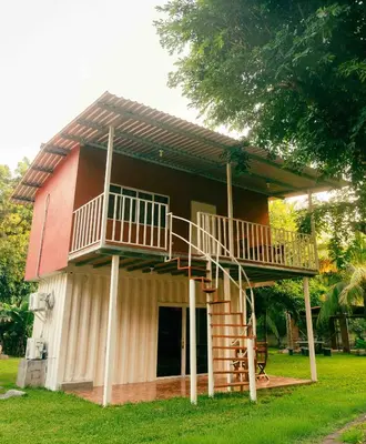 a house with a staircase on the side of it at Hotel Castillo Blanco in El Zonte