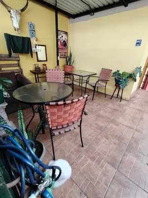 a restaurant with tables and chairs in a room at Rooms libertad in San Salvador