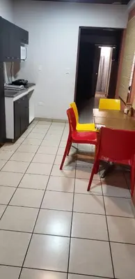 a kitchen with a table and yellow and red chairs at Casablanca in San Salvador