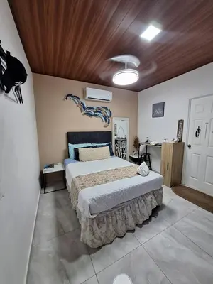 a bedroom with a large bed in a room at Villa Sunzal Surf Retreat' in La Libertad
