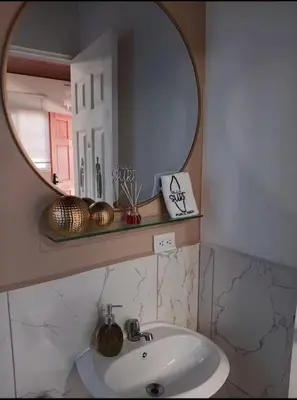 a bathroom with a sink and a mirror at Villa Sunzal Surf Retreat' in La Libertad