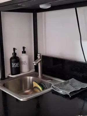 a kitchen sink with two bottles on the counter at Villa Sunzal Surf Retreat' in La Libertad