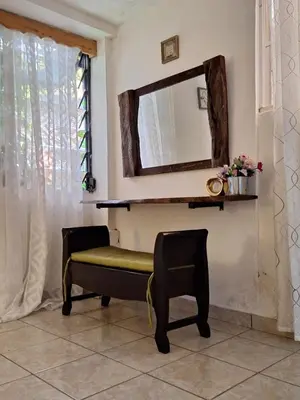 a mirror and a chair in a room at Apartamento Rústico in Concepción de Ataco