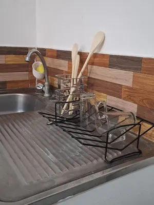 a kitchen sink with a metal rack with spoons at Apartamento Rústico in Concepción de Ataco