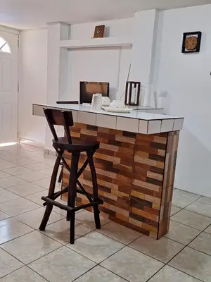 a kitchen with a counter with a stool next to it at Apartamento Rústico in Concepción de Ataco