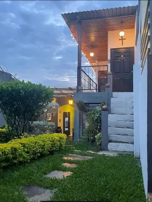 a house with a staircase leading to the front door at Apartamento Rústico in Concepción de Ataco