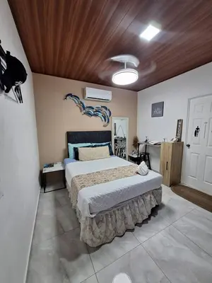 a bedroom with a bed with a blue dragon on the wall at Villa Surf Retreat in La Libertad