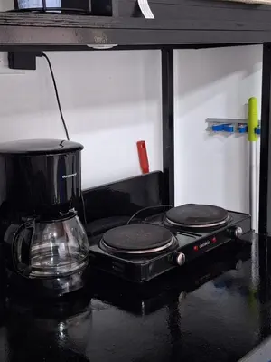 a coffee maker sitting on top of a stove at Villa Surf Retreat in La Libertad