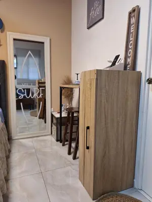 a kitchen with a wooden cabinet in a room at Villa Surf Retreat in La Libertad