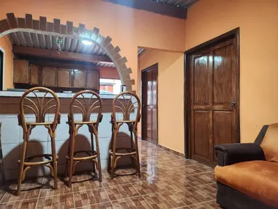 a kitchen with a table and chairs in a room at Linda casa con garaje en la majada