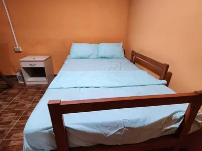 a bedroom with a bed with blue sheets and a night stand at Linda casa con garaje en la majada