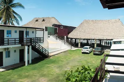 a view of a house with a thatch roof at Beachfront Hotel near International Airport in Las Hojas