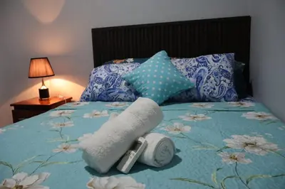 a bed with a rolled up towel on it at Costabay in El Zapote