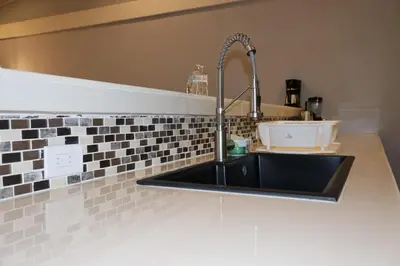 a kitchen sink with a faucet on a counter at Costabay in El Zapote