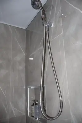 a shower with a shower head in a bathroom at Costabay in El Zapote