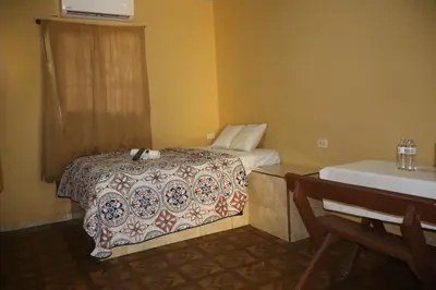 a bedroom with a bed with a comforter on it at habitacion costabay in San Luis La Herradura