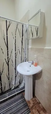 a bathroom with a white sink and a mirror at habitacion costabay in San Luis La Herradura