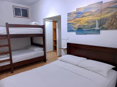 a bedroom with two bunk beds and a painting on the wall at Mar Adentro San Blas in Playa San Blas