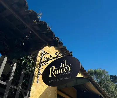a sign for a restaurant on the side of a building at Hotel Raíces Ataco in Concepción de Ataco