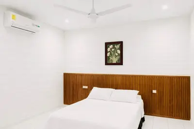 a bedroom with a bed with a wooden headboard at Hotel Raíces Ataco in Concepción de Ataco