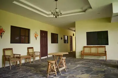 a room with chairs and a table and a table and benches at Hotel Raíces Ataco in Concepción de Ataco