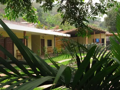 a house in the middle of a garden at Hotel Raíces Ataco in Concepción de Ataco