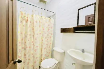 a bathroom with a toilet and a sink at Hotel Raíces Ataco in Concepción de Ataco