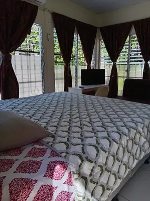 a large bed in a room with windows at Zacatecoluca House Hostel 2 nivel in Zacatecoluca